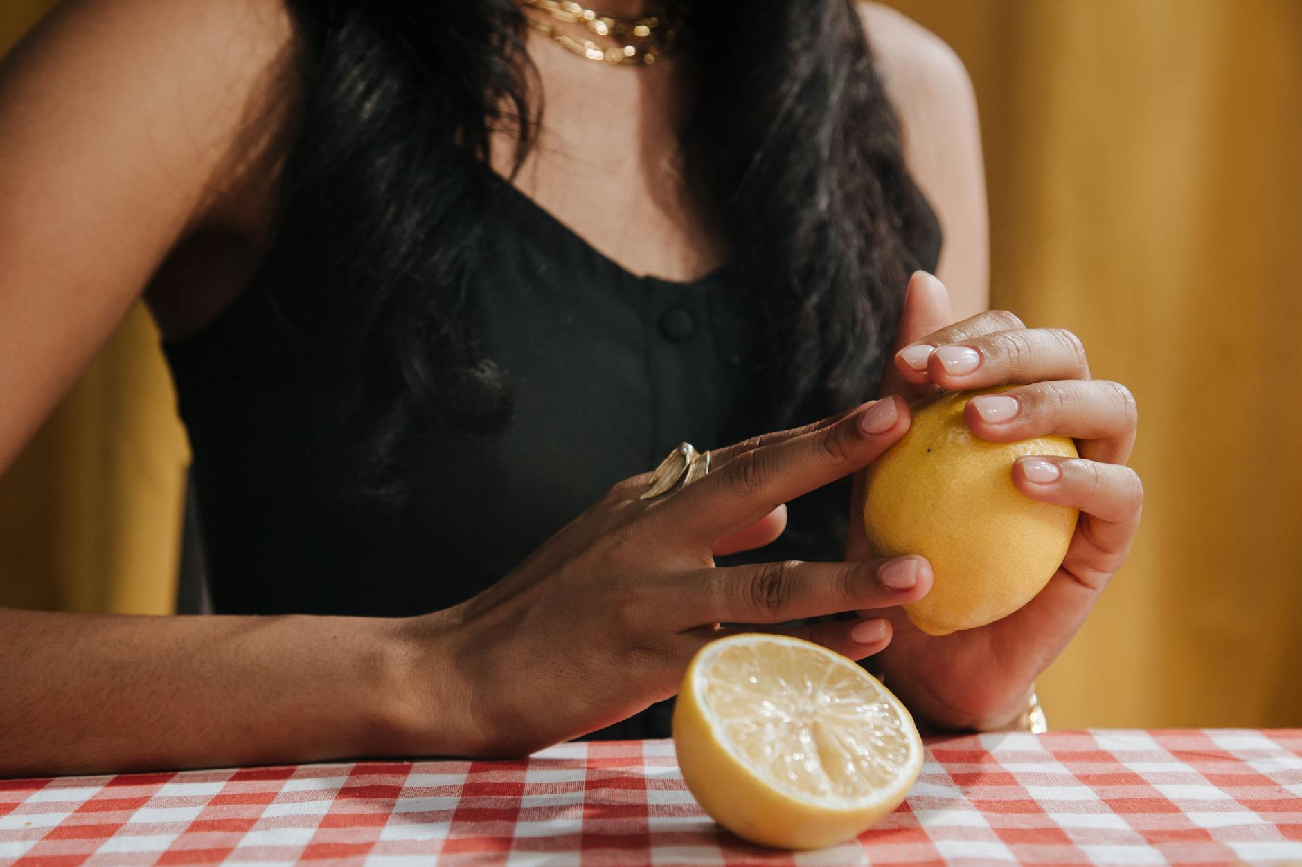 A woman holding a fresh lemon, symbolizing renewal and gentle reconnection