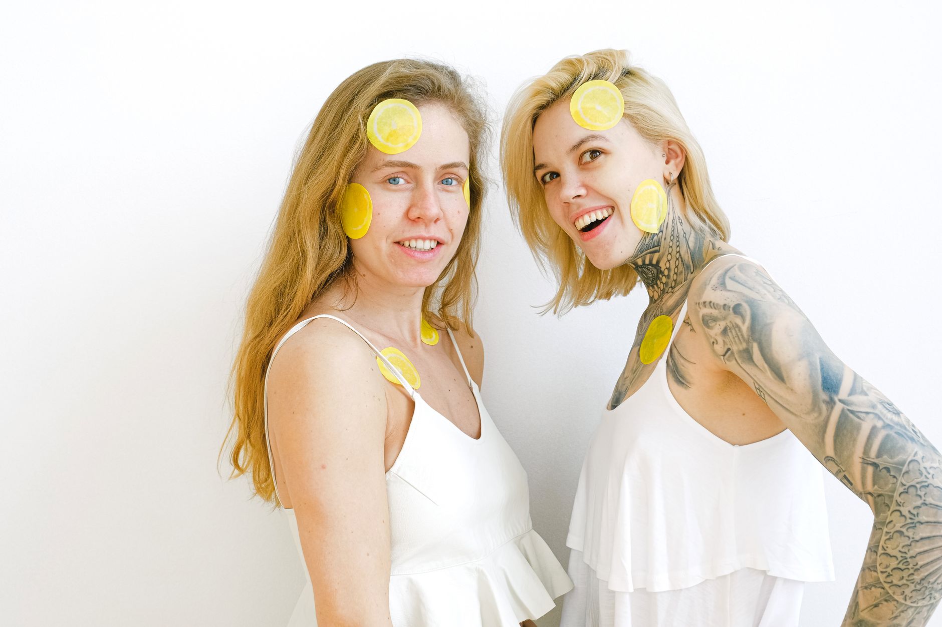 Yellow silicone vibrator surrounded by peeled bananas on yellow background