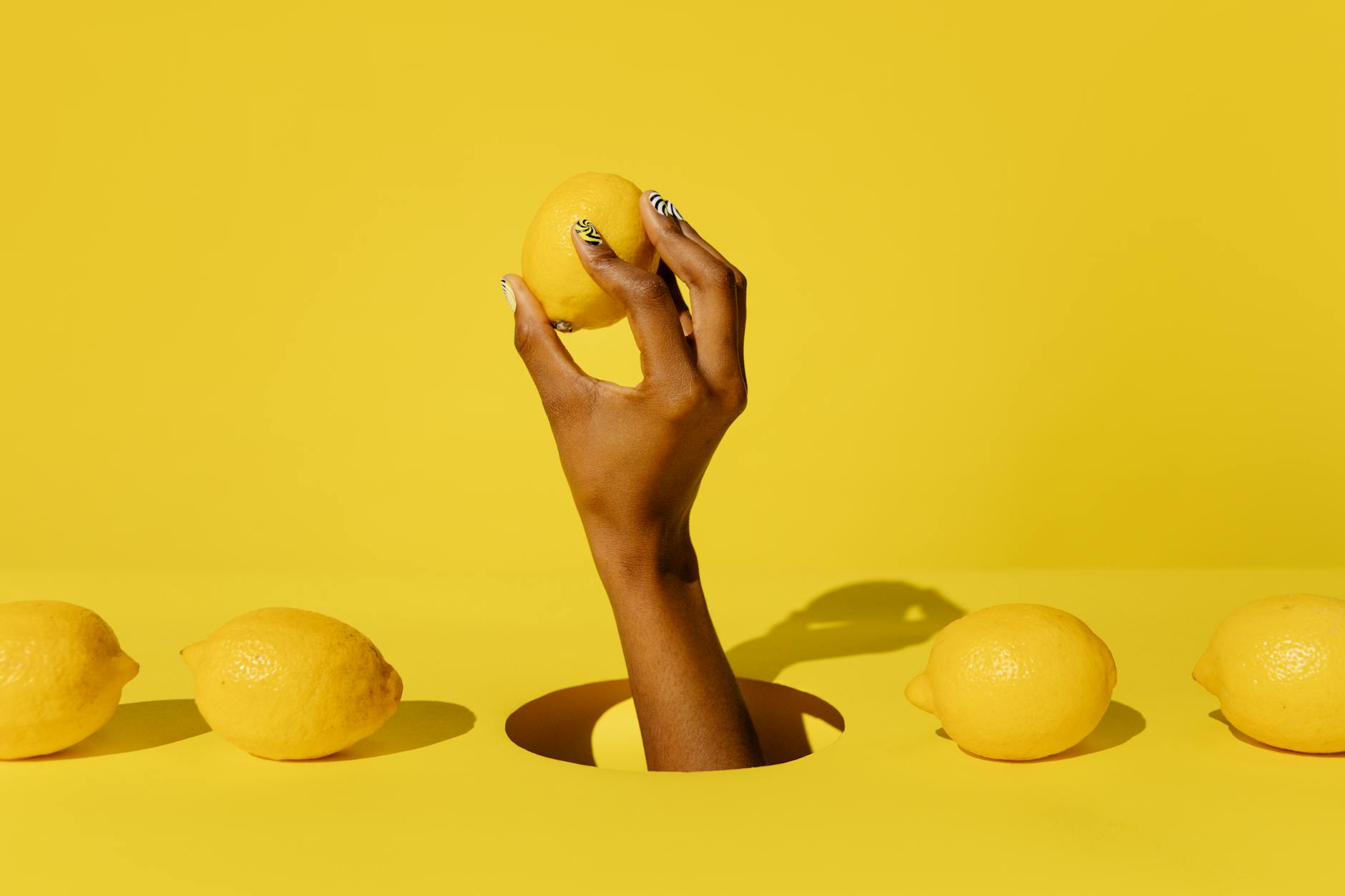 A yellow silicone vibrator surrounded by fresh bananas on a bright yellow background, representing the gentle, playful design of lemon sexual toys.